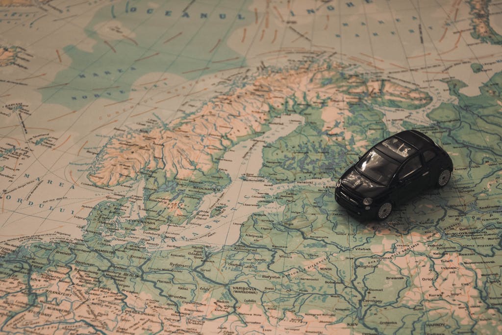 A miniature black car on a detailed map of Scandinavia, symbolizing travel adventures.
