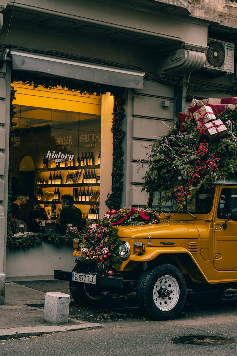 Holiday-themed jeep with gifts and greenery in a bustling Bucharest street scene.