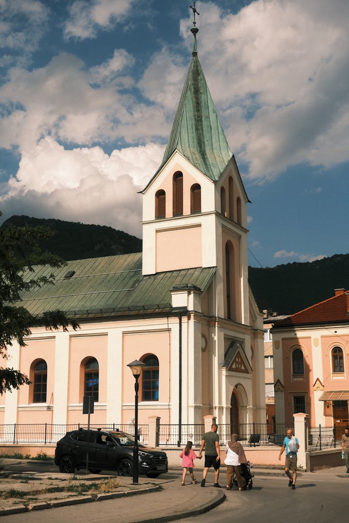 A beautiful day at a historic church in Travnik, Bosnia with people enjoying the surroundings.