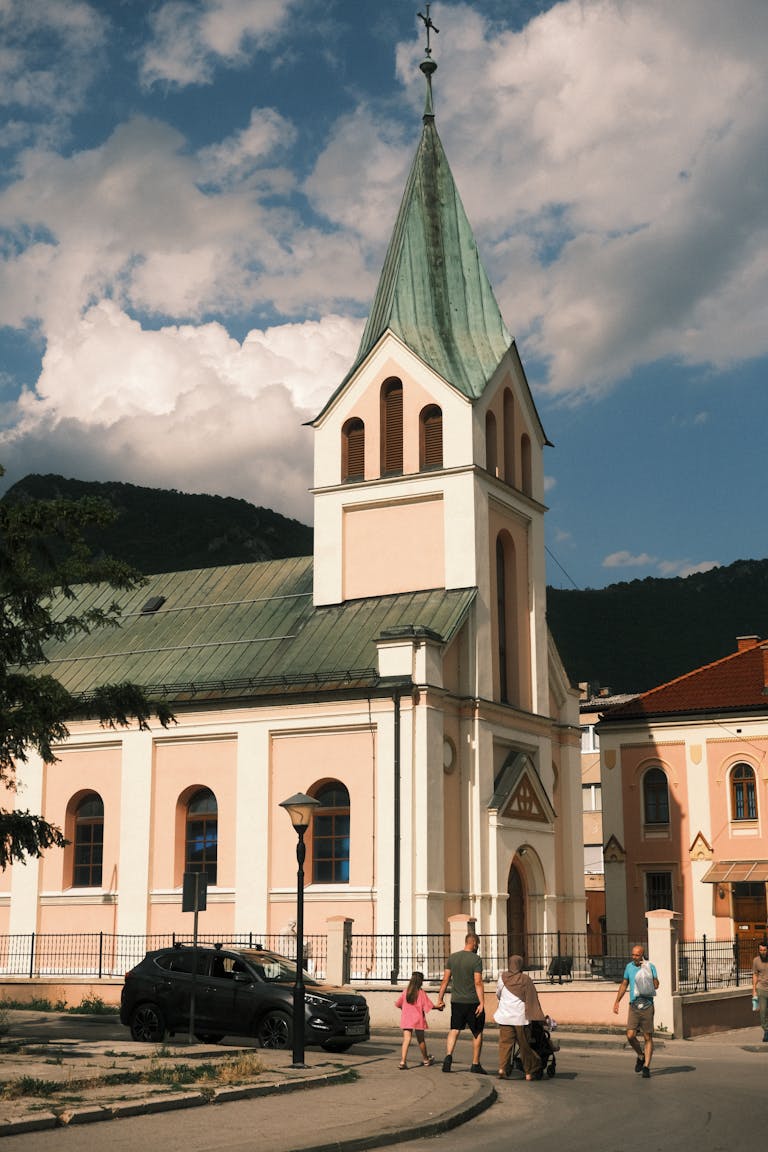 A beautiful day at a historic church in Travnik, Bosnia with people enjoying the surroundings.